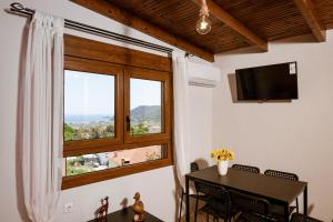 a dining room with a table and a window at Velpina Apartments in Potamiá