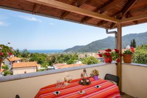 a table on a balcony with a view at Velpina Apartments in Potamiá