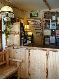 a bar in a restaurant with a table and a bench at Wildwood Inn in Twain Harte