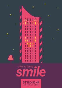 a poster of a tall pink building with the words smile at Studio 44 in Leipzig