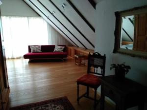 a living room with a red couch and a mirror at Katharina in Kempen