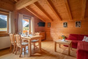 a living room with a table and a couch at Haus Panoramablick in Kals am Großglockner