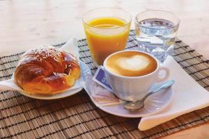 a cup of coffee and a pastry and a glass of orange juice at Inlaguna in Venice
