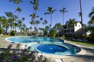 a pool at a resort with palm trees at Hotel Playa Colibri in Las Terrenas