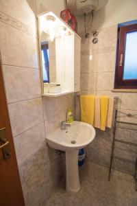 a bathroom with a sink and a mirror at Apartments Angela 1711 in Rakalj