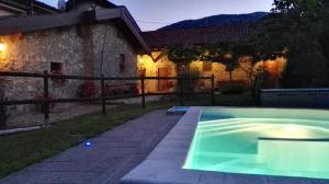 a swimming pool in front of a house at La Costa Di Gavedo in Gavedo