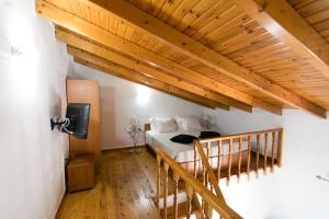a bedroom with a bed and a wooden ceiling at Apartments Barbie in Rethymno Town