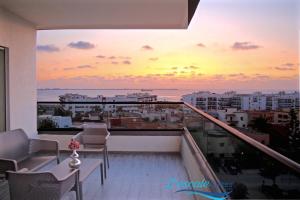 a balcony with a view of the ocean at sunset at L'escale Suites Résidence Hôtelière By 7AV HOTELS in Mohammedia