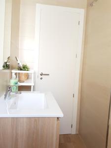 a bathroom with a white sink and a mirror at Apartamentos Los Corralejos in Fuengirola