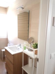 a bathroom with a sink and a mirror at Apartamentos Los Corralejos in Fuengirola