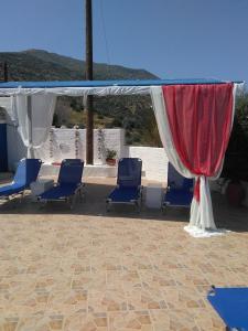 a group of blue chairs under a canopy at Studios Avra in Akhladherí