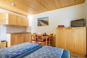 a bedroom with a bed and a kitchen with a table at S4 Resort Kouty in Loučná nad Desnou