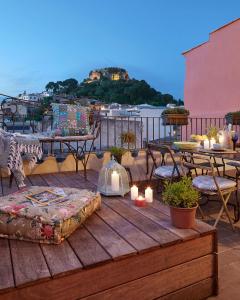 a table topped with a table cloth and chairs at La Indiana de Begur, Petit Hotel Boutique in Begur