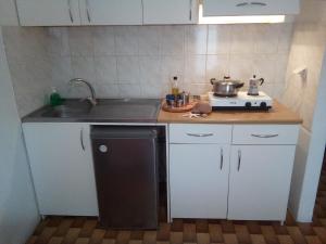 a small kitchen with a sink and a stove at Bissias Guest House in Galatas