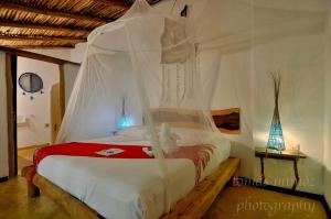 Säng eller sängar i ett rum på Pacha Tulum