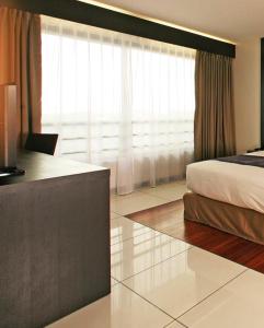 Voodi või voodid majutusasutuse Hotel Tahiti Nui toas