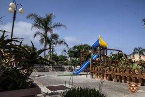 a playground with a slide in a park at Medusa MDNA in Marina di Modica