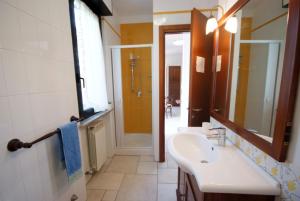 a bathroom with a sink and a mirror at Appartamenti Serenity - 2 posti auto - in villa e in centro in Marina di Campo +38 photos