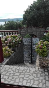 een tuin met een hek en wat bloemen bij Apartment Dunja in Senj