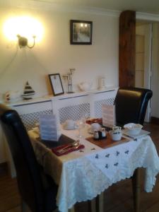 a dining room table with a white table cloth on it at Sea Lodge B&B in Durrus