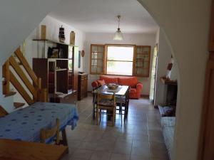 a living room with a table and a couch at Casa Vacanze Gardenia in Solanas