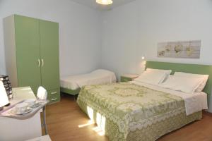 Postel nebo postele na pokoji v ubytování Albergo La Rosetta