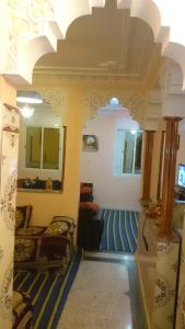 a room with a bed and a couch in it at Elmenzah Apartments in Taroudant
