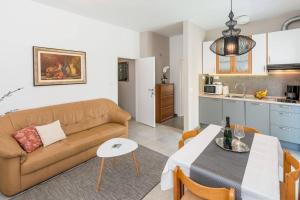 a living room with a couch and a table at Apartments Medora in Rovinj