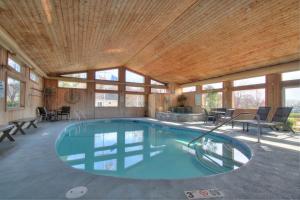 a swimming pool in a house with a wooden ceiling at Sea Mist Resort Motel in Wells
