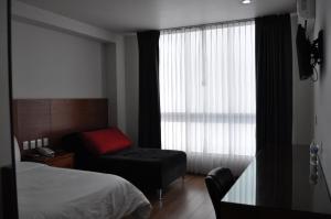 Ένα ή περισσότερα κρεβάτια σε δωμάτιο στο AMD Hotel