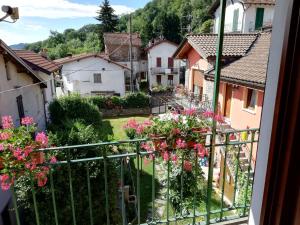a view from the balcony of a village with flowers at Campino in Stresa