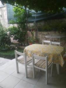 una mesa con 2 sillas y una mesa con mantel amarillo en Apartments Dijana en Budva