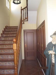 a hallway with stairs and a door with a blanket at Apartamento Rural Lobo in Ucero