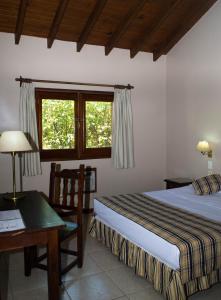 A bed or beds in a room at Marcopolo Suites Iguazu