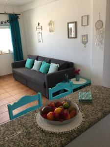 a living room with a bowl of fruit on a table at DOCEVIDA Appartement # Ocean View in Salema