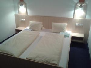 a large white bed in a room with two pillows at Apart Ramona in Serfaus