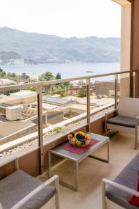 a balcony with a bowl of fruit on a table at Lux Apartments Harmonia in Budva