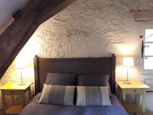 ヴィランドリーにあるGîte de la bergerieのベッドルーム1室(ベッド1台、テーブルにランプ2つ付)