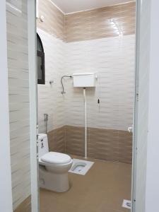 a small bathroom with a toilet and a sink at Alarbee Aljeded in Salalah +24 photos