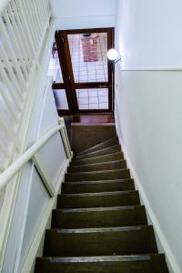 a staircase leading up to a room with a window at Piano B&B + Coworking in Porto Alegre