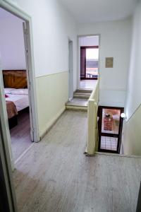an empty room with a staircase and a bedroom at Piano B&B + Coworking in Porto Alegre