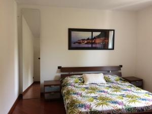 a bedroom with a bed and a mirror on the wall at Casa Lorenzo in Bellagio