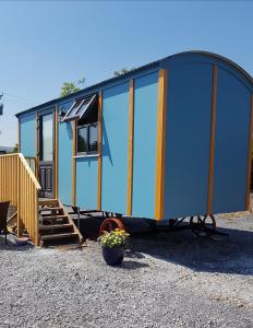 a tiny house with a large glass wall at Dingle Way Glamping in Anascaul