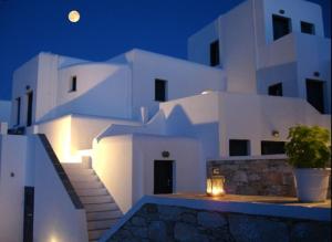 a large white building with stairs and a moon at Belvedere Apartments in Chora Folegandros