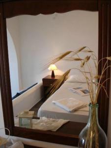 a mirror reflection of a bed in a bedroom at Belvedere Apartments in Chora Folegandros