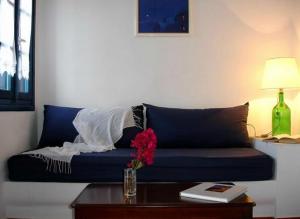 a blue couch in a living room with a table at Belvedere Apartments in Chora Folegandros