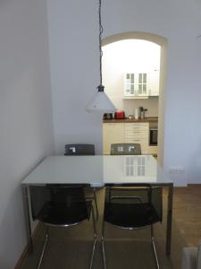 eine Küche mit einem weißen Tisch und 2 Stühlen in der Unterkunft Historisches Bürgerhaus Dresden -Kulturstiftung- in Dresden