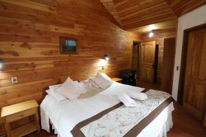 Cama ou camas em um quarto em Santa Maria Pucon