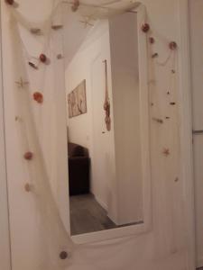 a mirror hanging on a wall with a room at Casa Giummarra in San Vito lo Capo