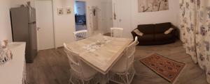 a living room with a table and a couch at Casa Giummarra in San Vito lo Capo +17 photos